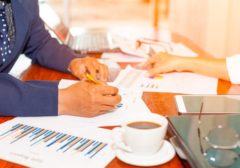 close up hands of business people working on table wiht morning light.Selective focus.