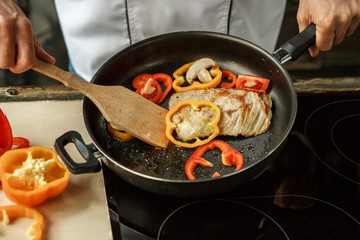  Mature man professional chef cooking meal indoors
