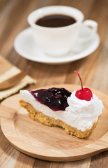 slice of blueberry cheese cake on wooden plate