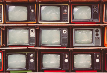 A lot of colorful old television decorate in coffee shop vintage tone.