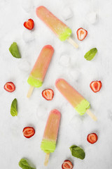 Multi-colored popsicles on a white background. Top view. Food background