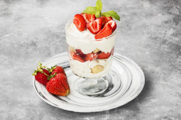 Dessert tiramisu with strawberry on a gray background