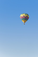 Isolated Hot Air Balloon in a blue sky