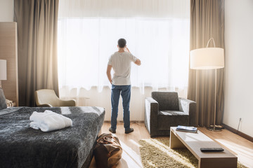 Young man traveler tourist hotel room accomodation