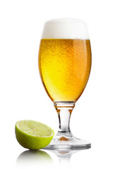 Cold fresh glass of beer with lime slice