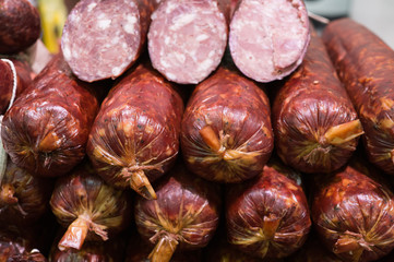 Food plat with delicious salami, pieces of sliced ham, sausage, cooked in a traditional way.