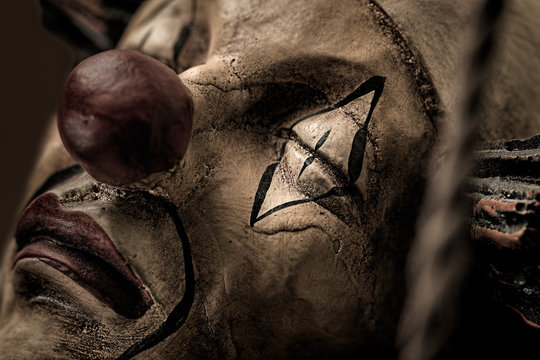 Desaturated image of wooden ornamental clown
