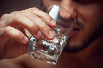Closeup of male adult drinking alcohol