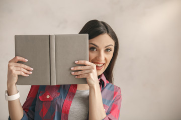 Young woman with a book studio portrait