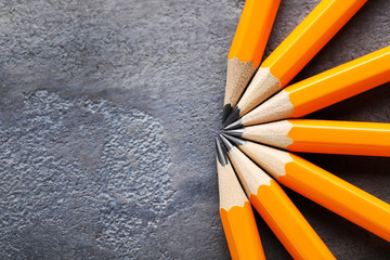Yellow pencils on grey wooden table