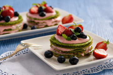 Homemade spinach cake with strawberry mousse
