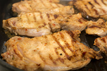 Steaks average frying in a grill pan