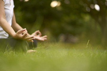 Woman relaxing Yoga in the park, Meditation for peace of mind. - obrazy, fototapety, plakaty