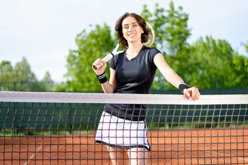 Beautiful young girl on the open tennis court