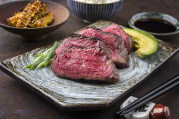 Japanese Kobe Steak Fillet with Rice and Avocado as close-up on a plate