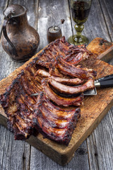 Barbecue Pork Spare Ribs as top view on an old cutting board.