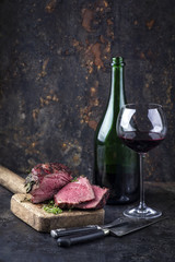 Barbecue Wagyu Point Steak with a Glass of Red Wine as close-up on an old metal sheet