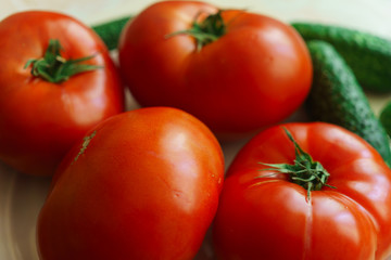 Fresh, ripe red tomatoes and pickled cucumbers.