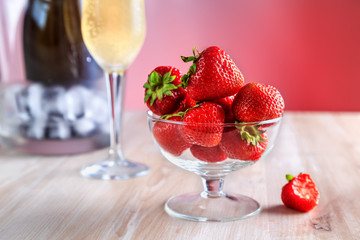 strawberries in a glass vase stands on the table