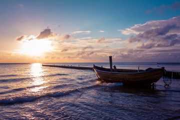Coastline with a special dreamy mood on the beach with a wooden boat