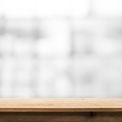 Wood table top on blur glass window wall building background.For montage product display or key...