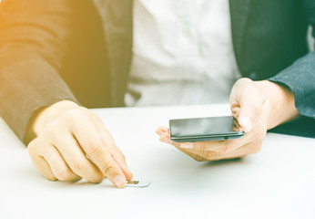 Hand holding sim card and smart phone, select focus, color effect