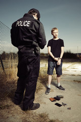Police man catching youth pickpocket with three wallets