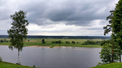 Fototapeta na wymiar Cloudy summer landscape with river