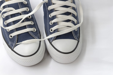 Blue sneakers are on a white background.