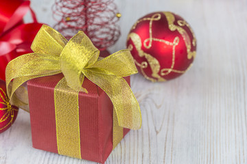 red xmas decorations and gift box with beautiful bow