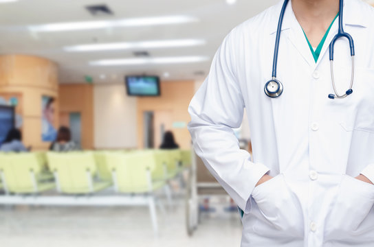 smart doctor with a stethoscope around his neck with blurred image of people waiting at hospital background, healthcare medical technology concept, copy space, color effect tone