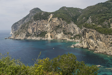 Obraz premium Sea rocks along Ionian sea coast in Paleokastritsa resort in June. Corfu Island, Greece