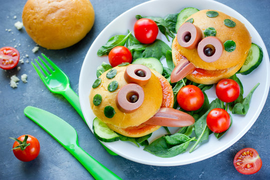 Cute frog shaped hamburger on a plate with fresh vegetables