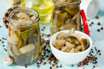 Delicious preserved marinated mushrooms in the glass jar