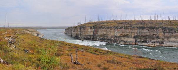 Panorama of rapid in a rocky canyon.