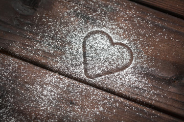 powdered sugar heart on wooden background
