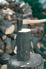 Felling firewood with an ax with a blurred background.
