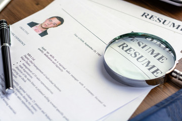 Business resume with man portrait on desk with business accessories