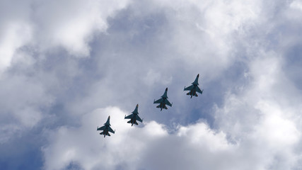 Naklejka na ściany i meble Group of military aircraft in the sky