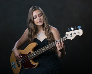 Young woman playing bass guitar