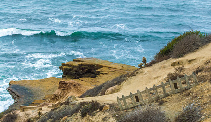 weathered fence and cliffs overlooking Pacific ocean at Point Loma San Diego