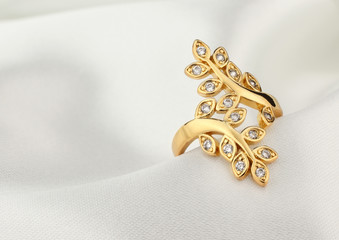jewelry ring with diamonds on white cloth, soft focus