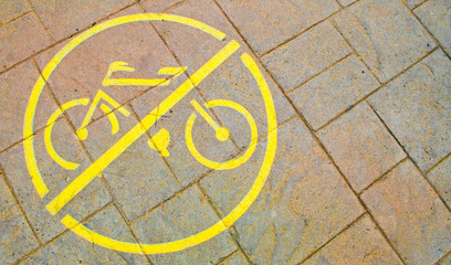 painted sidewalk sign prohibiting bicycles justified left