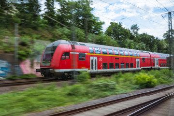 Red European Train Public Transport Motion Blur through Outdoors Area Traveling