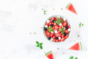 Watermelon salad and watermelon slices on white background. Top view, flat lay, copy space