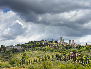 Fototapeta na wymiar dark clouds above the San Gimignano city in Tuscany in Italy