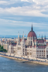 Fototapeta na wymiar Travel and european tourism concept. Parliament and riverside in Budapest Hungary during summer sunny day with blue sky and clouds
