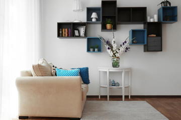 Living room interior with sofa and flowers