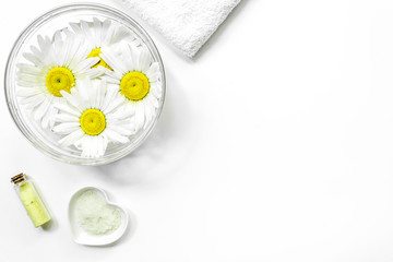 natural cosmetics design with chamomiles for manicure on white table background top view space for text