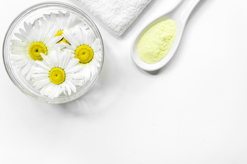 Spa composition with salt, chamomile and towel copyspase top view white background